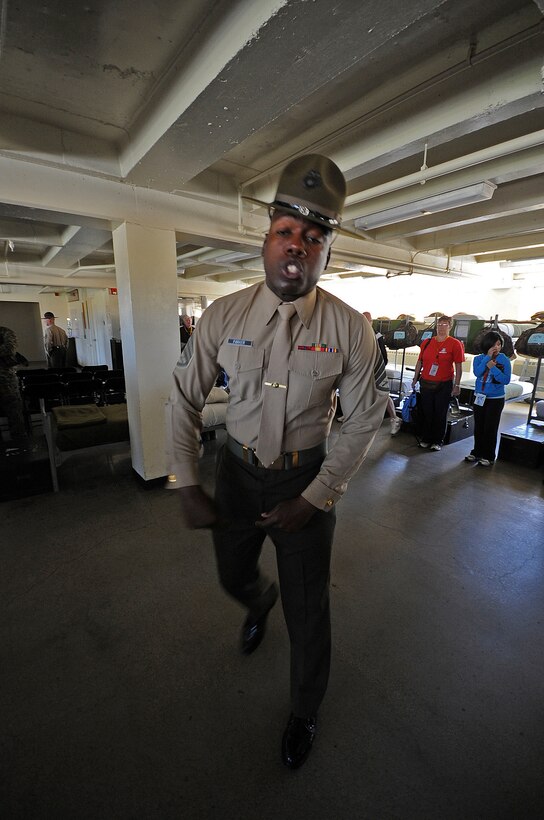 Drill Instructor Staff Sgt. Loen Parker simulates what happens to recruits when they first meet their drill instructors during the Educators Workshop on March 1 aboard Marine Corps Recruit Depot San Diego, Calif. Each year educators throughout the 10 states, which make up the 8th Marine Corps District, participate in the Educators Workshop, a five day event in Southern Calif. which allows high school teachers to experience Marine Corps recruit training.::r::::n::